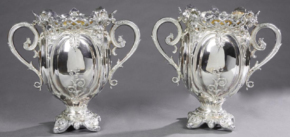 Pair of Elaborate English Silver Plate Wine Coolers, c.: Pair of Elaborate English Silver Plate Wine Coolers, c. 1881, the pierced scalloped rim with relief female busts, over a baluster body with applied handles, to a socle support on a relief decorated ba