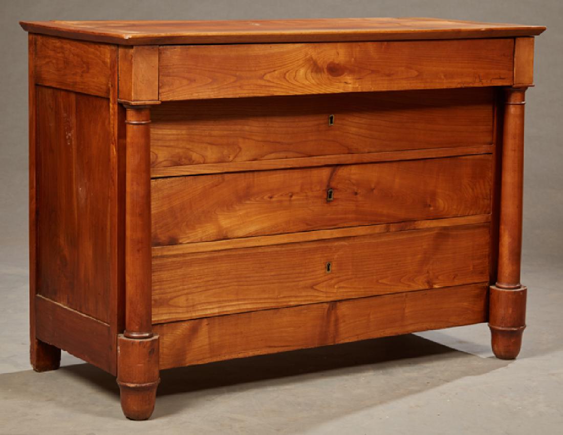 French Empire Style Carved Cherry Commode, early 19th: French Empire Style Carved Cherry Commode, early 19th c., the rectangular top over a frieze drawer and three setback drawers flanked by turned columns on cylindrical feet, H.- 35 1/8 in., W.- 49 1/2 i