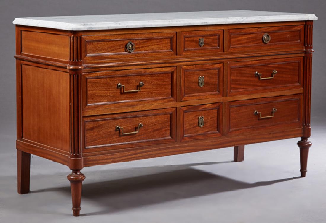 French Louis XVI Style Carved Mahogany Marble Top: French Louis XVI Style Carved Mahogany Marble Top Dresser, early 20th c., the figured white cookie cornered ogee edge marble top over a central bank of three drawers on each side, within fluted rounde