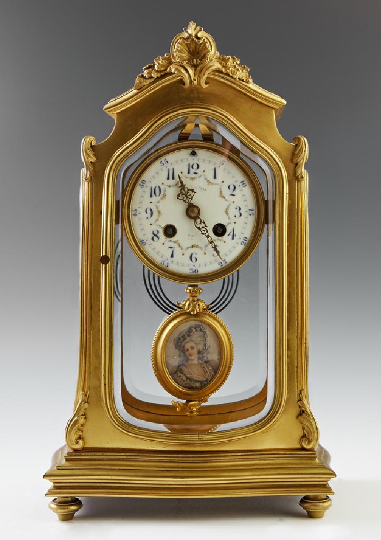 French Gilt Bronze Crystal Regulator Mantle Clock,: French Gilt Bronze Crystal Regulator Mantle Clock, early 20th c., the arched top with a beveled glass panel behind a leaf form crest, over beveled glass sides and door, containing a time and strike cl