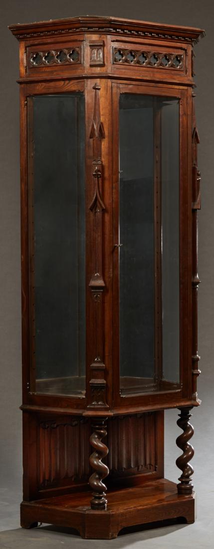 French Gothic Style Carved Oak Vitrine, late 19th c.,: French Gothic Style Carved Oak Vitrine, late 19th c., with a pierced quatrefoil and shield crest over a stepped pentagonal crown with pierced quatrefoils, over three wide beveled glazed doors, flanked