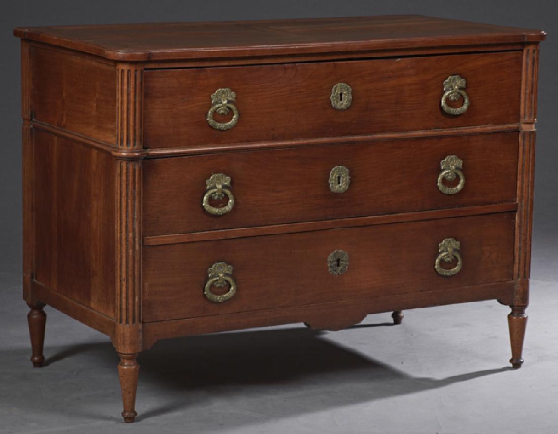 French Louis XVI Style Cherry Commode, c. 1770, the: French Louis XVI Style Cherry Commode, c. 1770, the stepped edge cookie corner top over a frieze drawer above two drawers, flanked by engaged fluted columns, on turned tapered legs joined by an arched