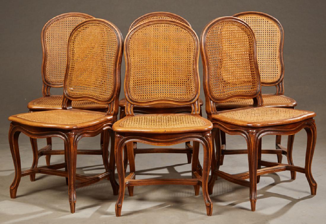 Set of Six French Louis XV Style Carved Walnut Caned: Set of Six French Louis XV Style Carved Walnut Caned Dining Chairs, early 20th c., the shaped medallion caned backs and bowed caned seats, on cabriole legs with toupie feet joined by an H-form stretch