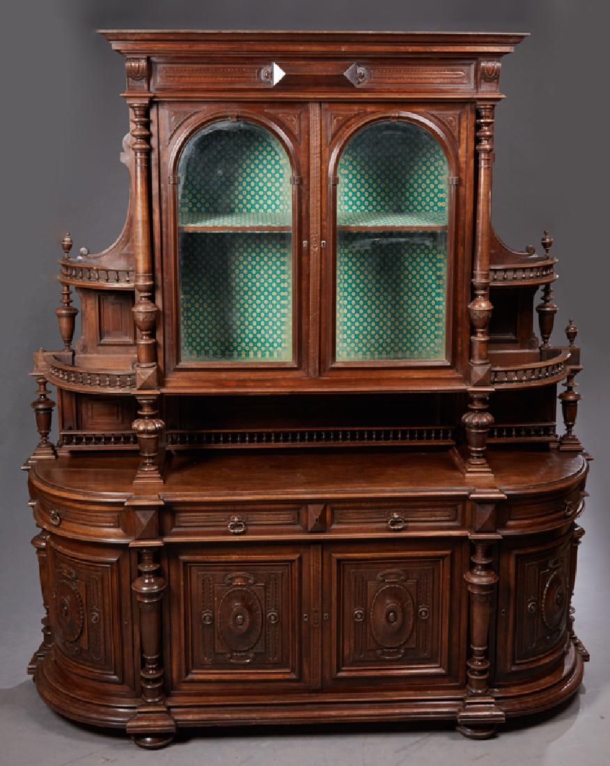Large French Henri II Style Carved Walnut Sideboard, c.: Large French Henri II Style Carved Walnut Sideboard, c. 1880, the stepped crown over setback double arched beveled glass doors flanked by turned columns and spindled graduated shelves on both sides, o