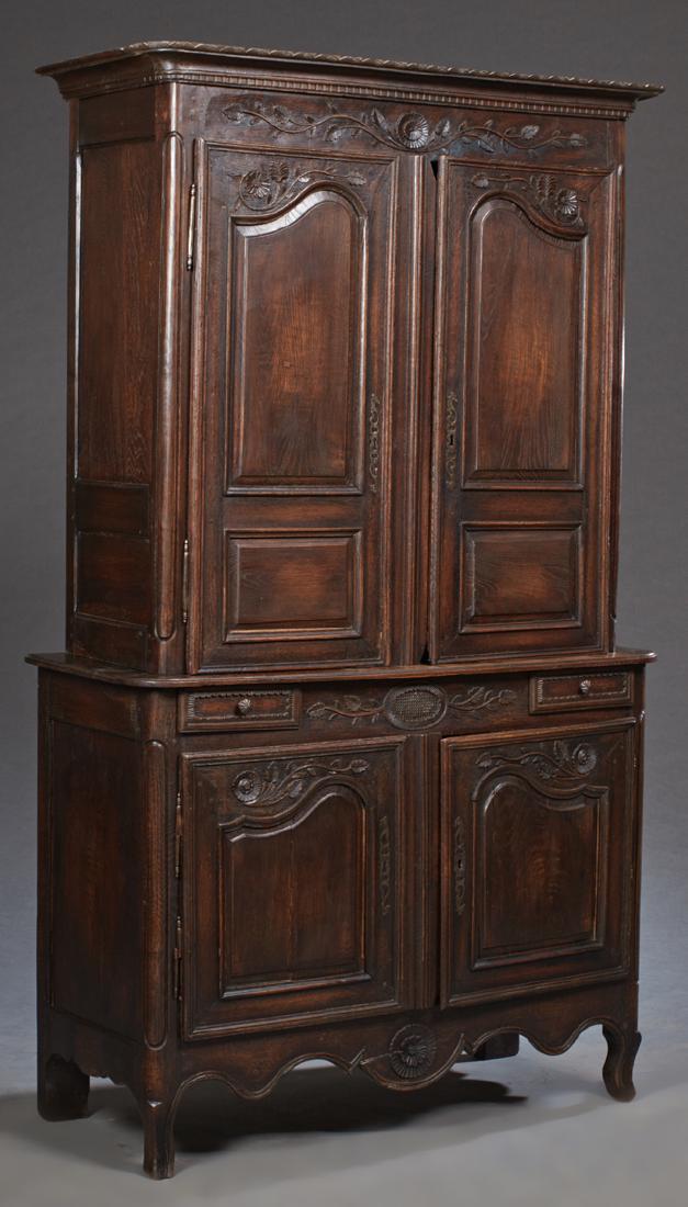 French Provincial Louis XV Style Carved Oak Buffet a: French Provincial Louis XV Style Carved Oak Buffet a Deux Corps, 19th c., the stepped dentillated rounded edge and corner crown over two double arched fielded panel cupboard doors with iron escutcheon