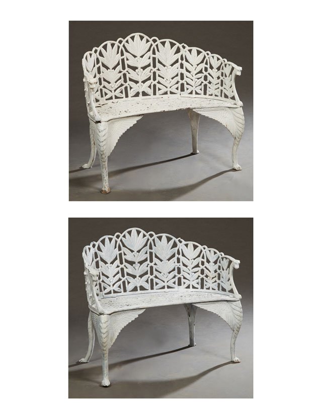 Pair of American Style Cast Iron Garden Benches, 20th: Pair of American Style Cast Iron Garden Benches, 20th c., the curved back with pierced floral decoration, to a pierced scrolled seat, flanked by arms with lions' head terminals, on winged cabriole leg