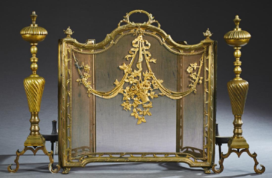 Two French Bronze Gilt Fireplace Items, late 19th c.,: Two French Bronze Gilt Fireplace Items, late 19th c., consisting of a pair of reeded ball andirons on scrolled legs and a gilt bronze folding fireplace screen with applied floral basket and drapery ap
