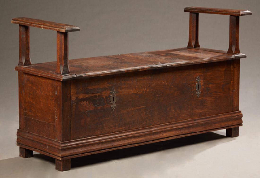 French Provincial Carved Oak Bench, early 19th c., the: French Provincial Carved Oak Bench, early 19th c., the stepped flat arms over double lifting lids, over open storage, H.- 31 in., W.- 54 in., D.- 20 in.