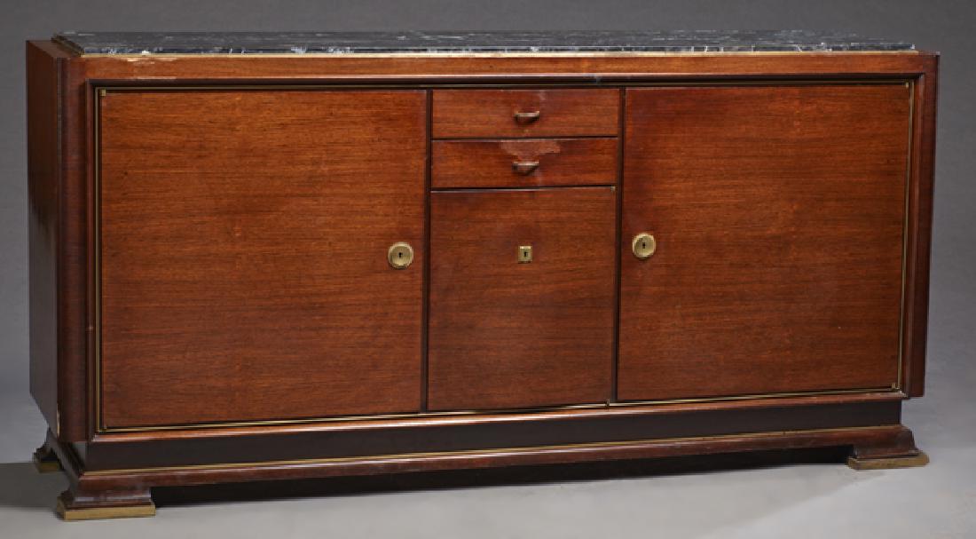 French Art Deco Carved Mahogany Ormolu Mounted Marble: French Art Deco Carved Mahogany Ormolu Mounted Marble Top Sideboard, c. 1940, the inset highly figured black marble over a central bank of two drawers above a cupboard, flanked by large cupboard doors