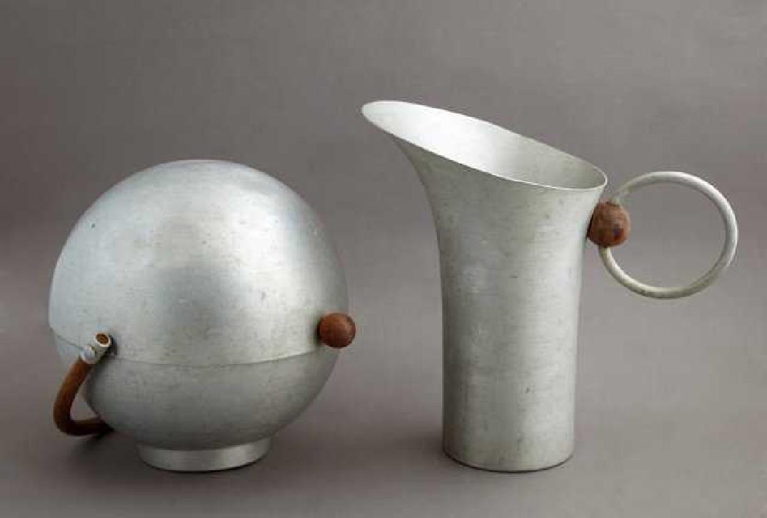 Russel Wright Mid Century Modern Spun Aluminum Pitcher: Russel Wright Mid Century Modern Spun Aluminum Pitcher and Bun Warmer, c. 1950, with wooden accents, Pitcher- H.- 10 1/8 in., W.- 10 3/4 in., D.- 6 1/8 in. (2 Pcs.)