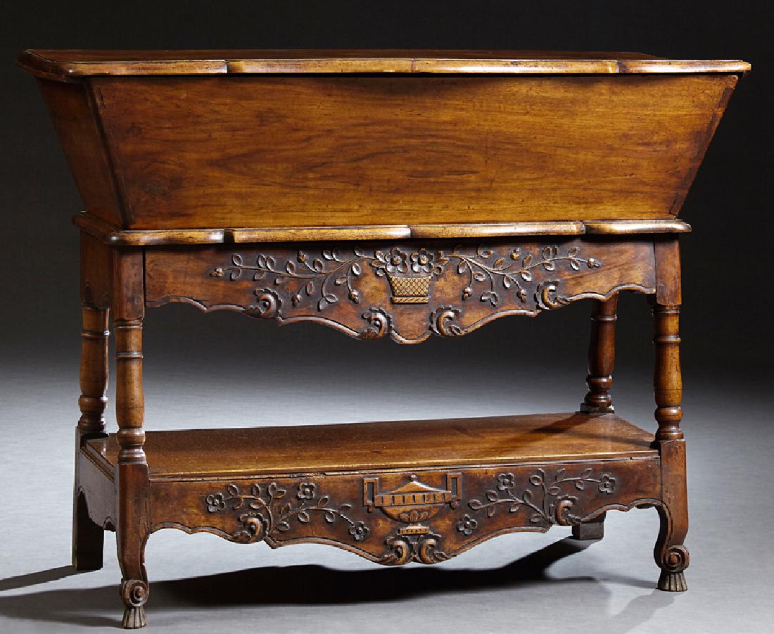 French Carved Walnut Petrin, 19th c., the hinged lift: French Carved Walnut Petrin, 19th c., the hinged lift top above a lower frieze drawer on turned splayed legs joined by a lower shelf, H.- 37 in., W.- 48 in., D.- 21 in.