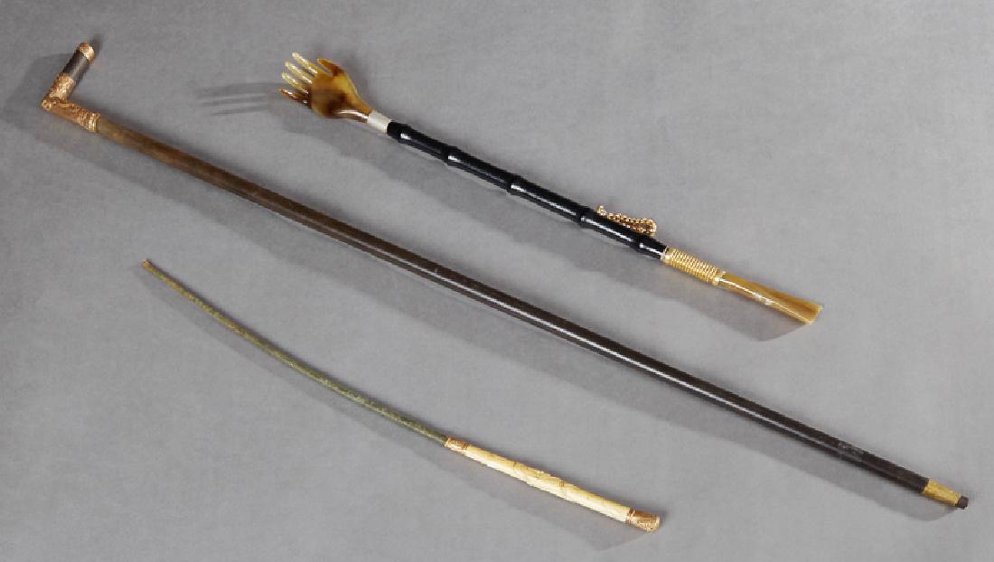 Group of Three English Edwardian Objects, c. 1910,: Group of Three English Edwardian Objects, c. 1910, consisting of a carved bone handled riding crop; a faux bamboo back scratcher with an agate hand; and a walking stick with a gold plated handle, Walk