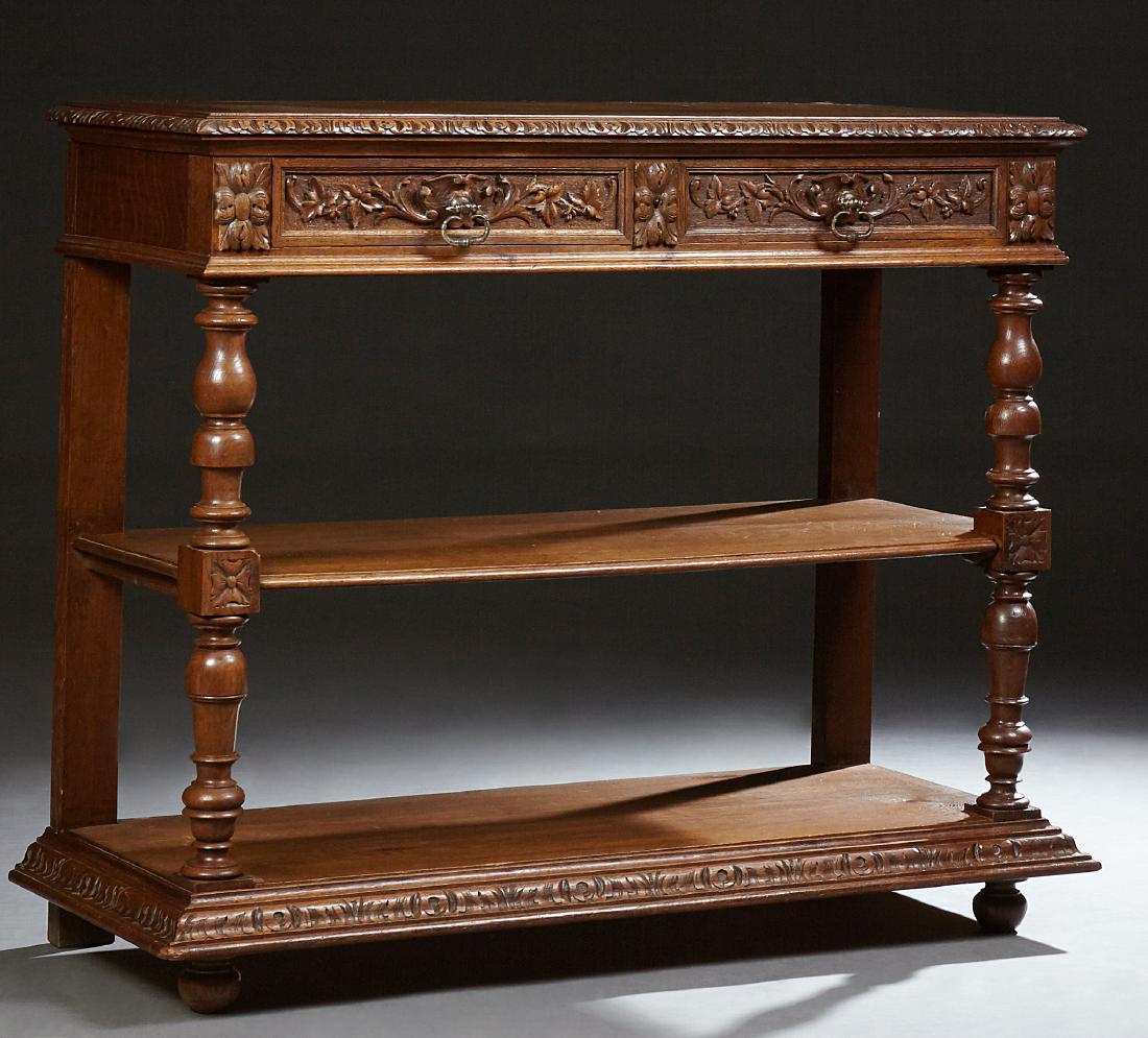 French Louis XIII Style Carved Oak Serving Trolley,: French Louis XIII Style Carved Oak Serving Trolley, late 19th c., the gadroon edge lifting top above an inset white marble, over two frieze drawers on turned supports, to a center shelf on like suppor