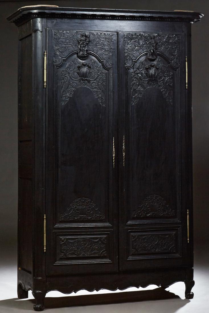 French Louis XV Style Oak Armoire, 19th c., the rounded: French Louis XV Style Oak Armoire, 19th c., the rounded corner crown above double figural arched doors with iron escutcheons and fiche hinges, on cabriole legs joined by a serpentine skirt, H.- 100 in