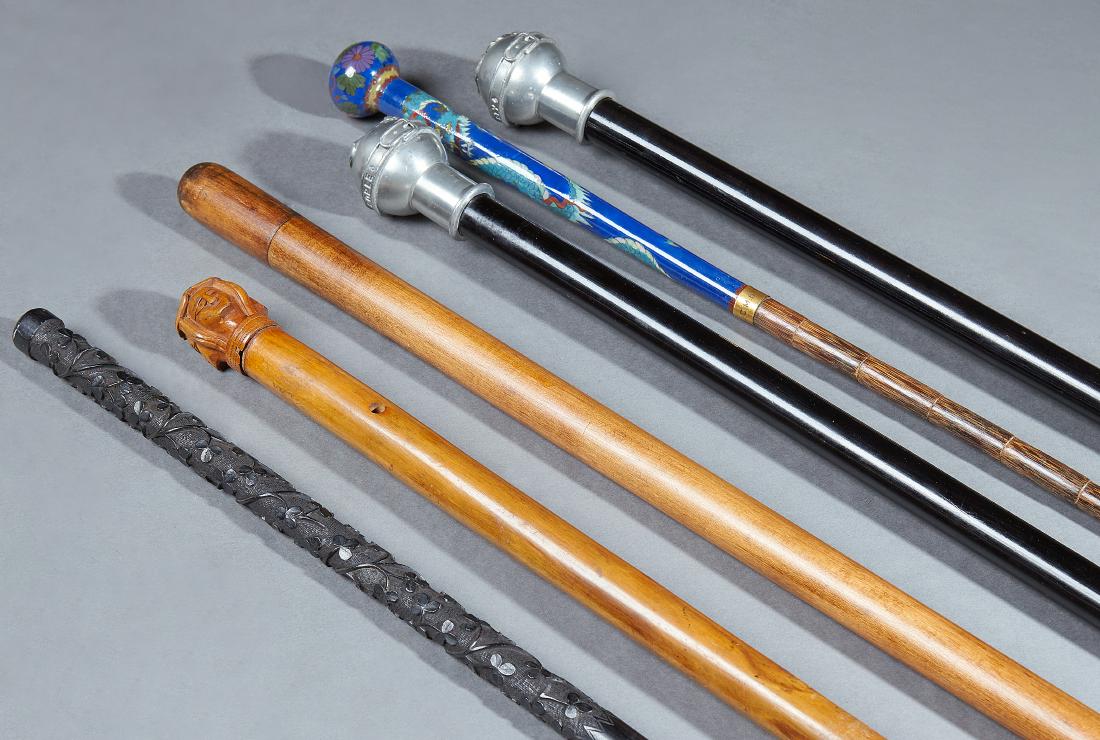 Group of Six Canes, early 20th c., consisting of a four: Group of Six Canes, early 20th c., consisting of a four furies example, an oriental cloisonnÃ© handled bamboo example, an Irish Walking Stick with a carved shamrock handle, a collapsing pool cue exa
