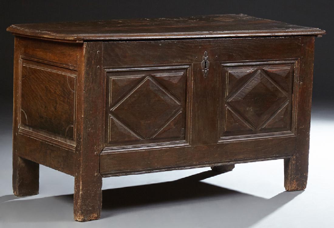 French Provincial Carved Oak Coffer, early 19th c., the: French Provincial Carved Oak Coffer, early 19th c., the two plank lid over fielded panel front and sides, on block feet, H.- 27 in., W.- 46 1/2 in., D.- 23 in.