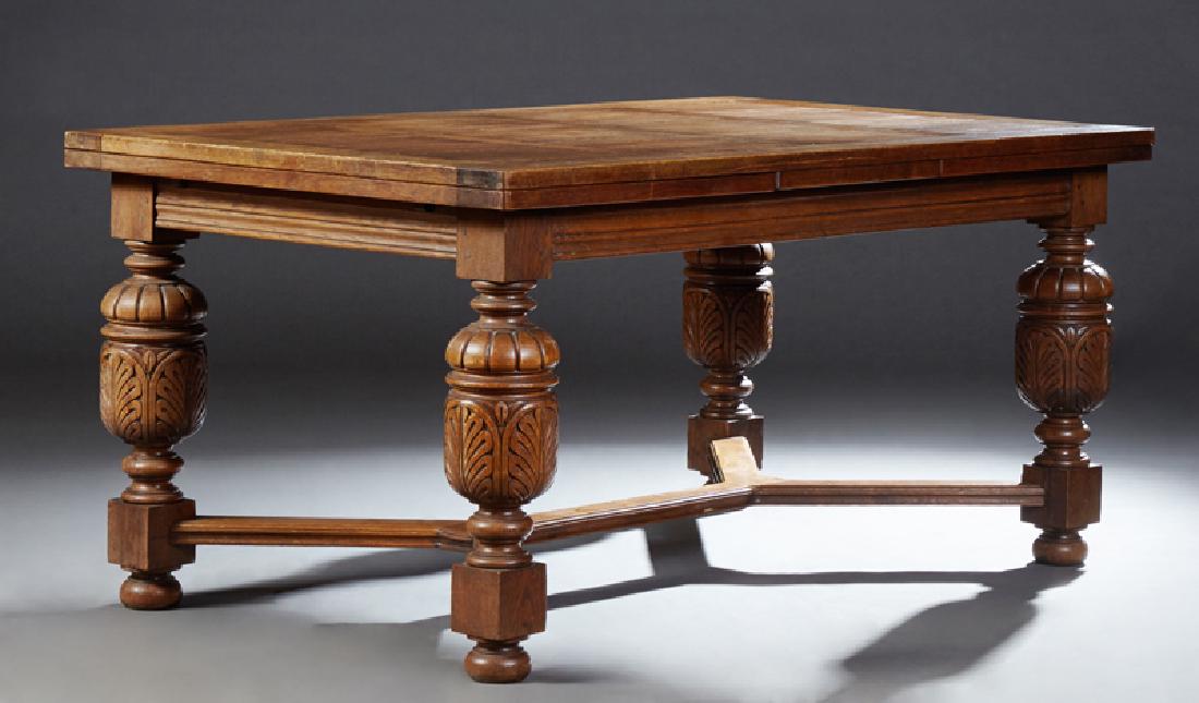 French Louis XIII Style Carved Oak Draw Leaf Dining: French Louis XIII Style Carved Oak Draw Leaf Dining Table, 19th c., the twelve panel rectangular top above a reeded skirt, on turned carved baluster urn supports with block and turned feet, joined by