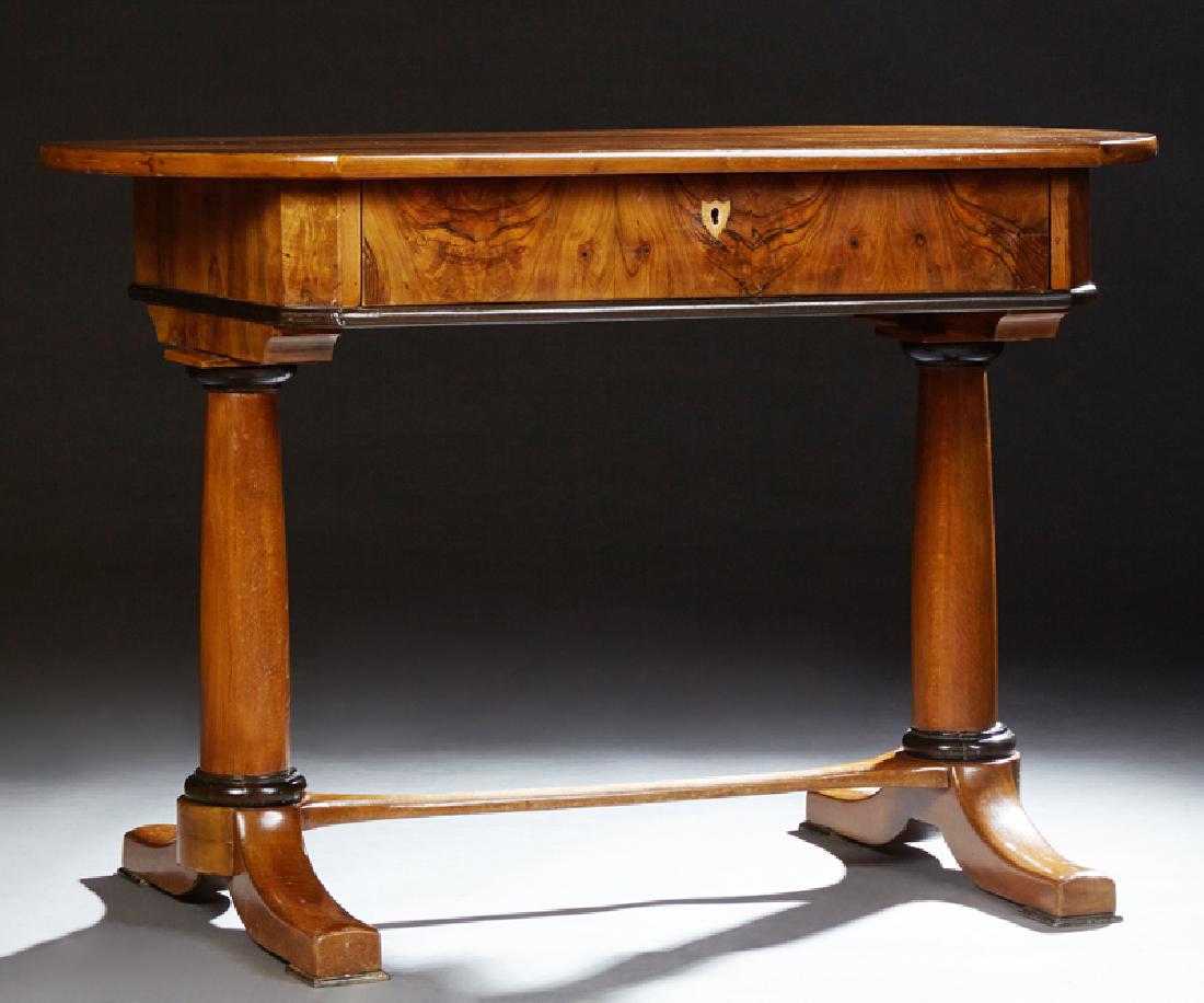 Biedermeier Writing Table, 19th c., the oval top over a: Biedermeier Writing Table, 19th c., the oval top over a frieze drawer, on turned tapered columnar trestle support, joined by a stretcher with ebonized accents, H.- 31 in., W.- 46 in., D.- 26 1/2 in.