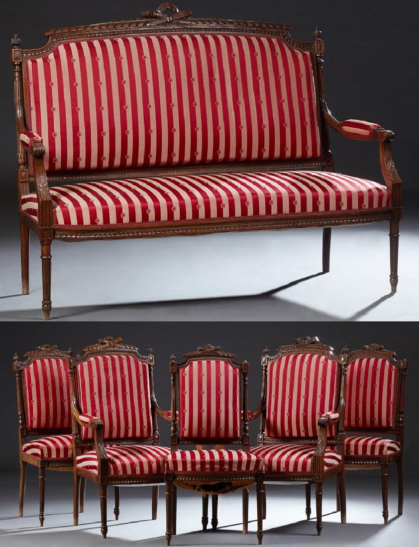 French Louis XVI Style Six Piece Carved Walnut Parlor: French Louis XVI Style Six Piece Carved Walnut Parlor Suite, early 20th c., consisting of two fauteuils, a settee and three side chairs, each with an arched pierced torch and quiver carved crest rail,