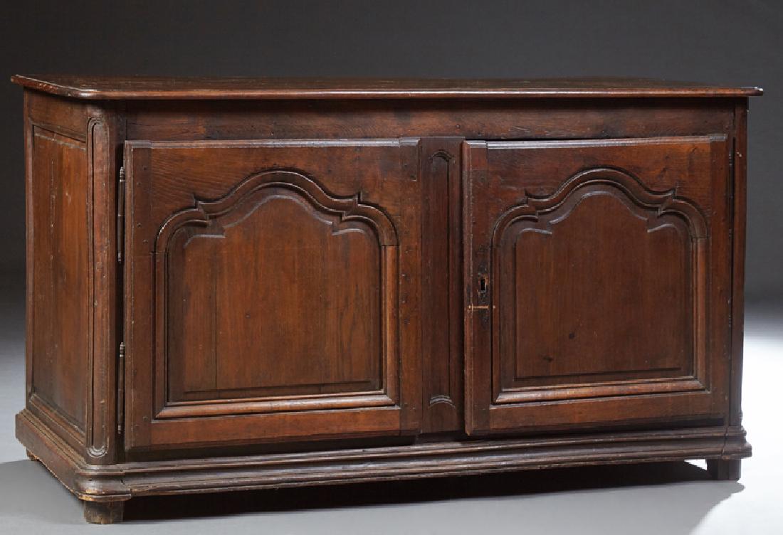 French Provincial Louis XV Style Carved Oak Sideboard,: French Provincial Louis XV Style Carved Oak Sideboard, 19th c., the rectangular round edge top over double fielded panel cupboard doors flanked by rounded corner stiles, on a plinth base on bun feet, 