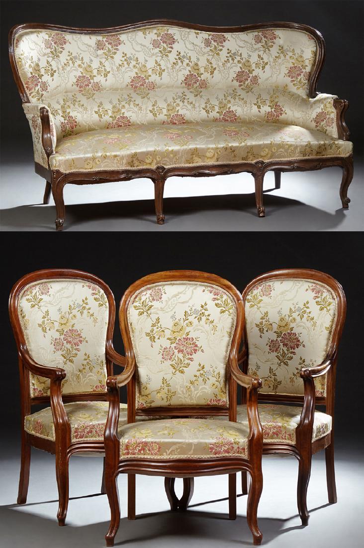 French Mahogany and Cherry Four Piece Parlor Suite,: French Mahogany and Cherry Four Piece Parlor Suite, 19th c., consisting of three arched fauteuils and a settee, with a hump back over upholstered arms and a serpentine seat, on cabriole legs with toup