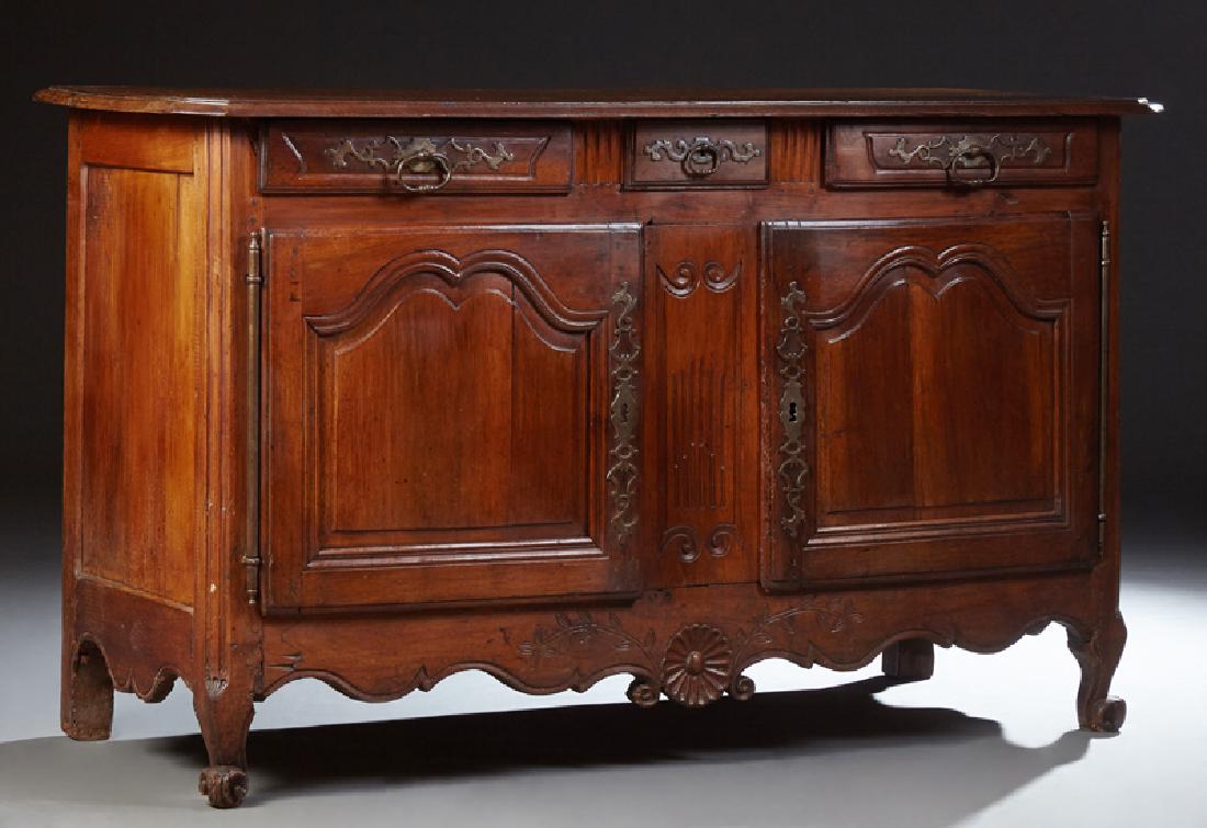 French Provincial Louis XV Style Carved Cherry and Oak: French Provincial Louis XV Style Carved Cherry and Oak Sideboard, 19th c., the rounded edge canted corner top over double frieze drawers above double fielded panel cupboard doors with long iron field 