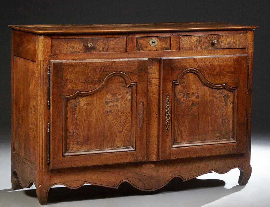 French Provincial Louis XV Style Carved Walnut: French Provincial Louis XV Style Carved Walnut Sideboard, 19th c., the rounded corner two board top above three frieze drawers over double arched cupboard doors, with iron built hinges and escutcheons