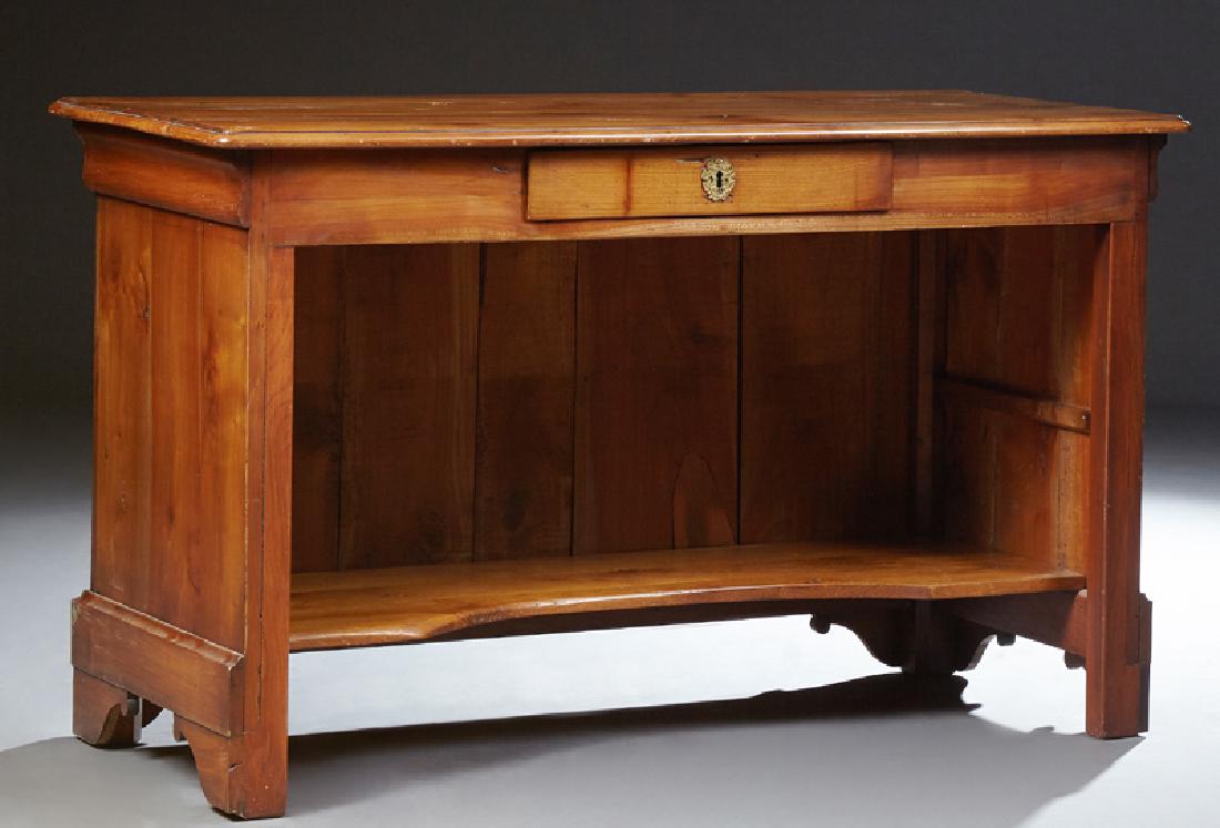 French Provincial Carved Cherry Desk, late 19th c., the: French Provincial Carved Cherry Desk, late 19th c., the stepped rounded corner top over a center frieze drawer above a concave shelf, on a bracket plinth base, H.- 30 3/8 in., W.- 50 1/2 in., D.- 23 1