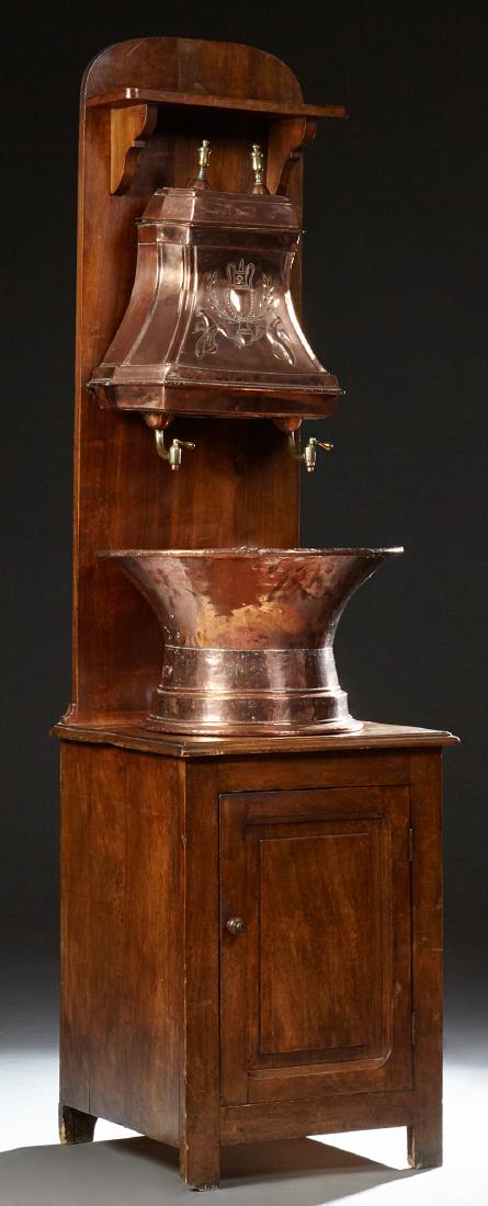 French Provincial Copper and Brass Lavabo, early 20th: French Provincial Copper and Brass Lavabo, early 20th c., with a copper and brass reservoir with double brass spigots, over a copper basin on a carved birch stand, the arched top over a shelf, on a st