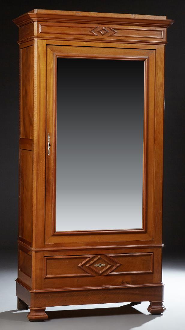 French Louis Philippe Style Carved Walnut Bonnetiere,: French Louis Philippe Style Carved Walnut Bonnetiere, late 19th c., the stepped canted corner crown over a wide beveled mirror door above a bottom frieze drawer, on ogee block feet, H.- 84 in., W.- 44