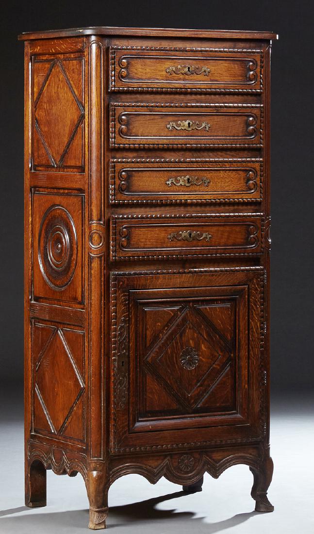 French Provincial Carved Oak Chiffonier, late 19th c.,: French Provincial Carved Oak Chiffonier, late 19th c., Brittany, the stepped edge rounded corner top over four drawers and a lower fielded panel cupboard door with iron fiche hinges and escutcheon, fl