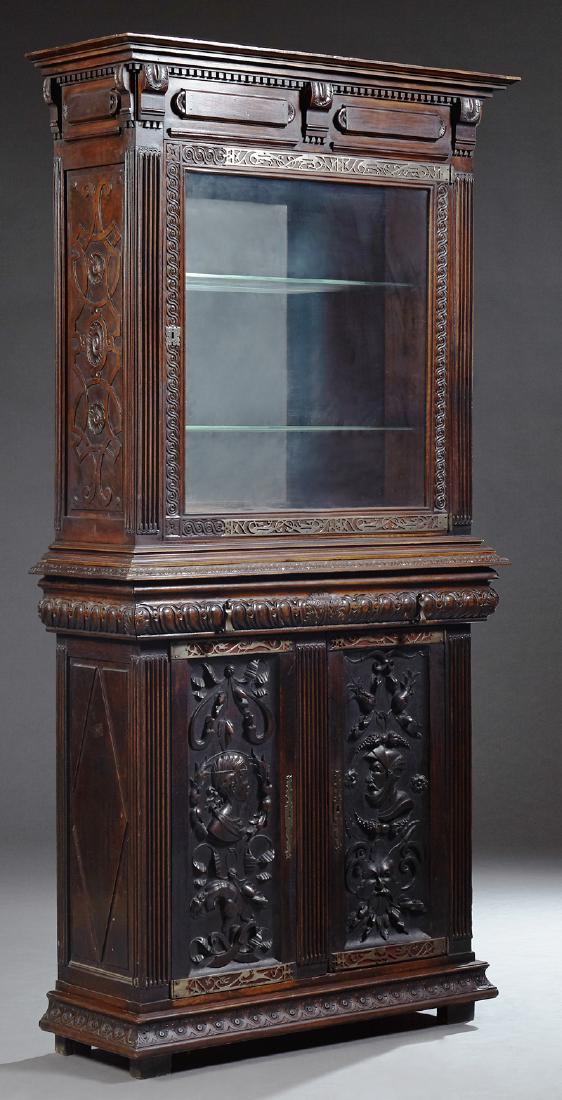 French Henri II Style Carved Oak Buffet a Deux Corps,: French Henri II Style Carved Oak Buffet a Deux Corps, c. 1880, the stepped crown over a glazed door with cut steel friezes, iron fiche hinges and escutcheon, flanked by reeded pilasters, on a base wit