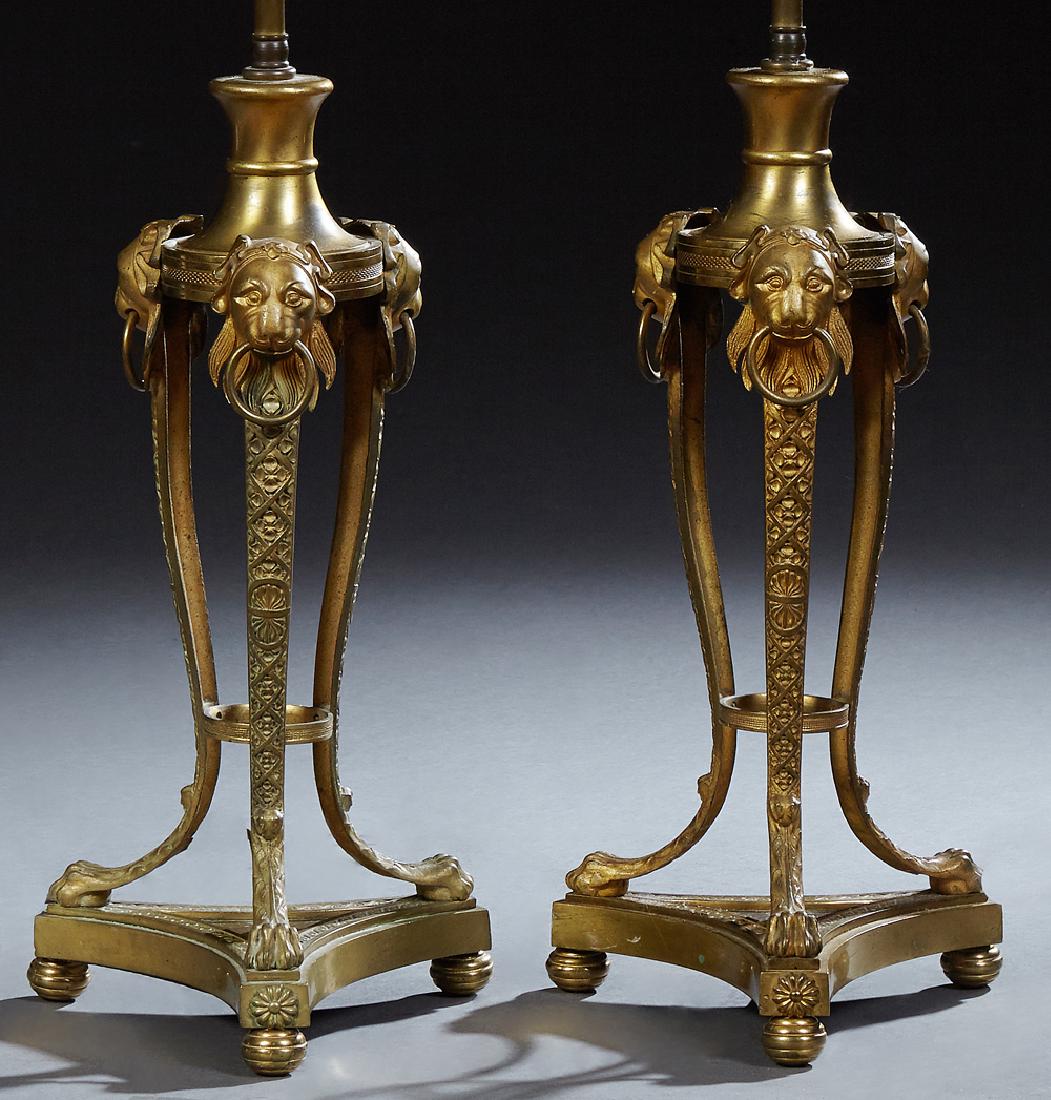 Pair of Continental Gilt Bronze Lamps, late 19th c.,: Pair of Continental Gilt Bronze Lamps, late 19th c., with a sloping top on tripodal lions head topped curved paw foot supports, to a triangular base on disc feet, H.- 16 in., Dia.- 7 3/4 in.