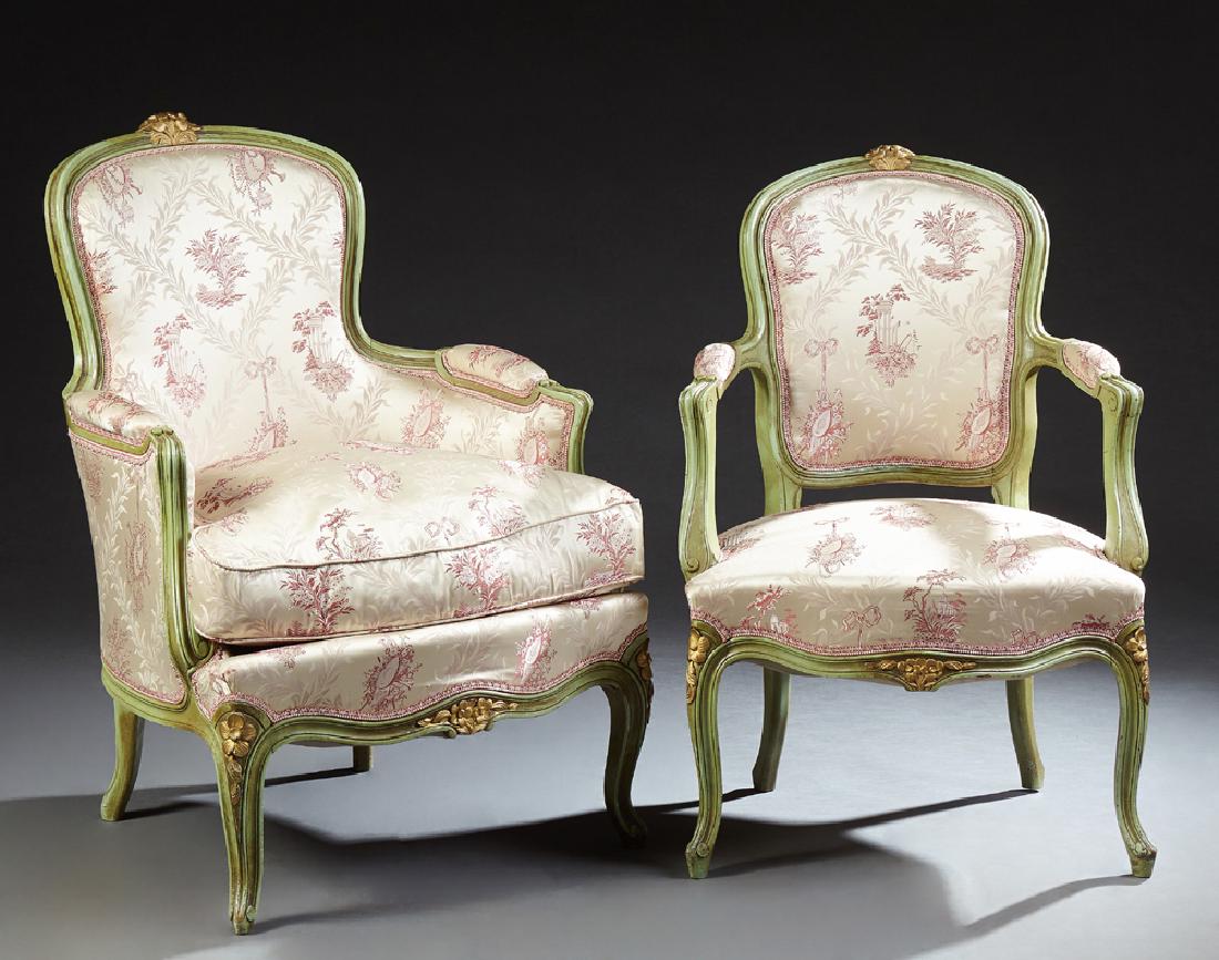 Two Louis XV Style Polychromed Beech Bergeres, 19th c.,: Two Louis XV Style Polychromed Beech Bergeres, 19th c., the arched floral carved crest above a curved upholstered medallion back to upholstered arms flanked a bowed seat, on cabriole legs with toupie 