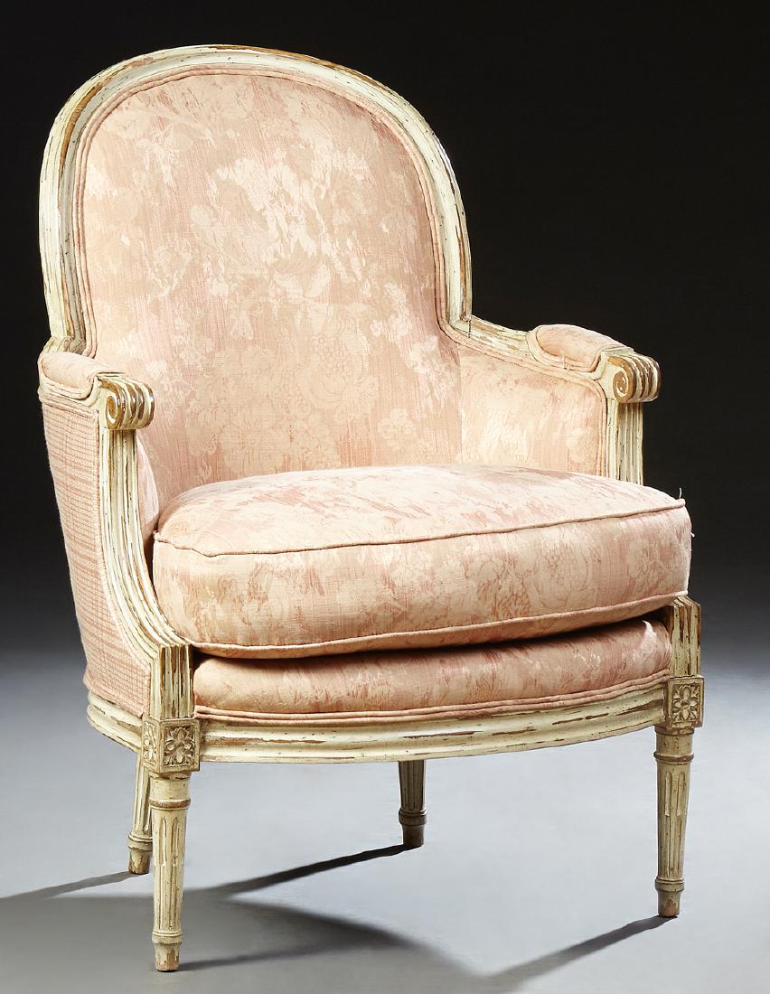 French Polychromed Upholstered Louis VI Style Bergere,: French Polychromed Upholstered Louis VI Style Bergere, early 20th c., the arched curved back over upholstered scrolled arms over a bowed cushion seat on turned tapered reeded legs, on toupie feet, now