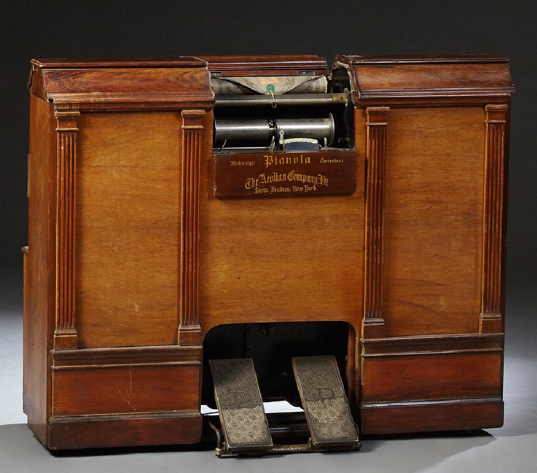 Neoclassical Style Carved Rosewood and Walnut Roll: Neoclassical Style Carved Rosewood and Walnut Roll Operated Pianola Player Piano, c. 1900, by the Aeolian Company, with Metrostyle and Thermodist technology, sixty-five notes, No. 45256, including one