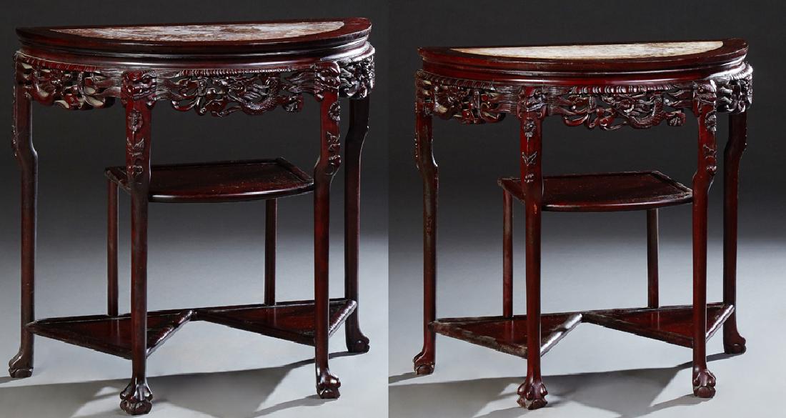 Pair of Chinese Carved Mahogany Demilune Marble Top: Pair of Chinese Carved Mahogany Demilune Marble Top Console Tables, early 20th c., the highly figured pink marble inset tops, over pierced bird and dragon skirts, on cabriole legs, joined by a bowed c