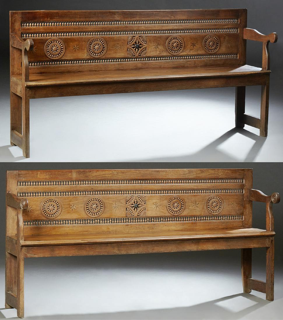 Pair of French Provincial Carved Oak Settees, 19th c.,: Pair of French Provincial Carved Oak Settees, 19th c., Brittany, the pierced spindled back flanked by curved arms, to a stepped edge bench seat, on block legs joined by block stretchers, H.- 38 1/2 in