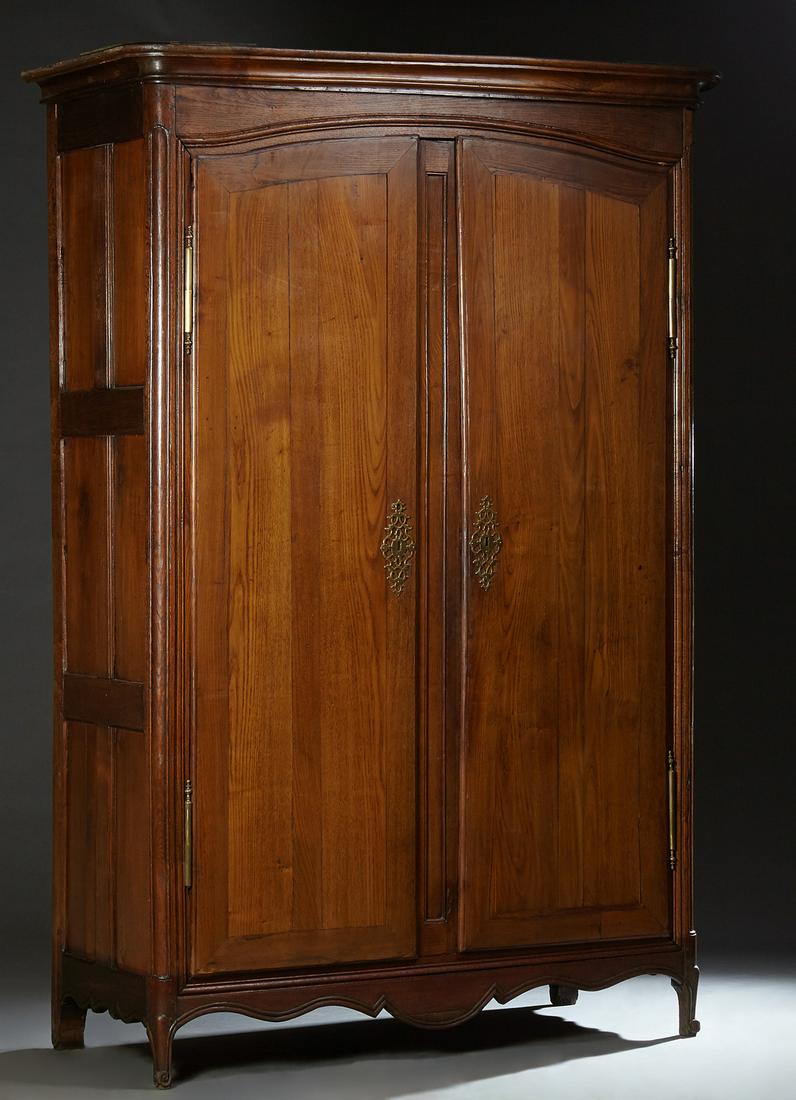 French Provincial Louis XV Style Carved Oak Armoire,: French Provincial Louis XV Style Carved Oak Armoire, early 19th c., the stepped rounded corner ogee crown over arched double doors with long iron fiche hinges and escutcheons, on scrolled cabriole leg