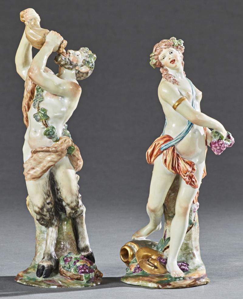 Two Polychromed Capodimonte Style Porcelain Figures,: Two Polychromed Capodimonte Style Porcelain Figures, late 19th c., of Pan with a wine skin, on an integral base with a tree trunk and a basket of grapes; and a nude woman holding a bunch of grapes, on