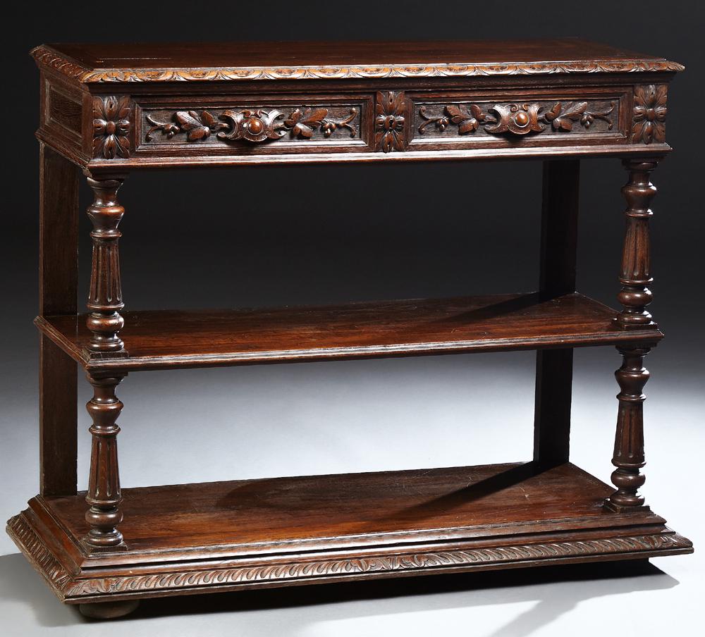 French Henri II Carved Oak Trolley, c. 1880, the carved: French Henri II Carved Oak Trolley, c. 1880, the carved edge top over two frieze drawers, on turned tapered reeded supports to a center shelf and a bottom stepped shelf, with a sloping edge, on flat d