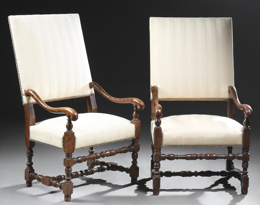 Pair of French Louis XIII Style Carved Beech Fauteuils: Pair of French Louis XIII Style Carved Beech Fauteuils a la Reine, 20th c., the canted rectangular backs to curved arms and cushion seats, on turned tapered legs joined by like stretchers, in ivory st