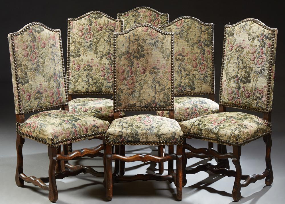 Set of Six Louis XIII Style Carved Beech Dining Chairs,: Set of Six Louis XIII Style Carved Beech Dining Chairs, 19th c., the arched crestrail above a canted back and trapezoidal seat, on serpentine legs joined by an H-form stretches, with iron tacked needl
