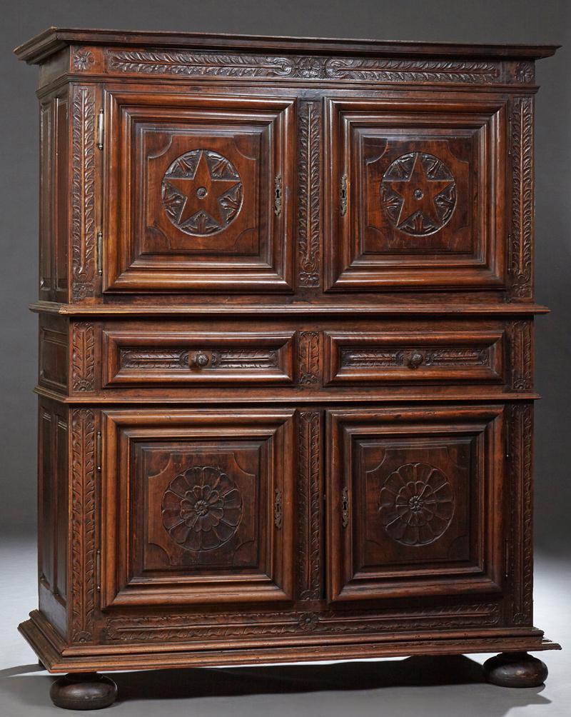 French Renaissance Style Carved Oak Homme Debout, 19th: French Renaissance Style Carved Oak Homme Debout, 19th c., the stepped crown above double cupboard doors with geometric relief decoration and iron escutcheons and fiche hinges, above two central friez