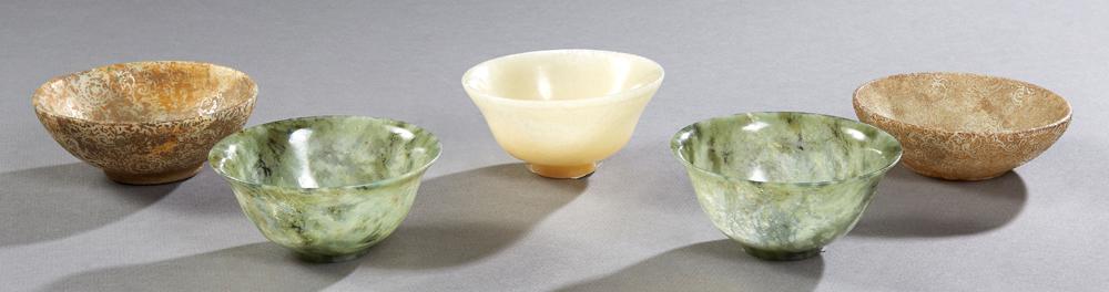 Group of Five Chinese Jade and Jadeite Footed Circular: Group of Five Chinese Jade and Jadeite Footed Circular Bowls, 19th and 20th c., two with chop marks on the underside and relief decoration on the interior and exterior, Largest- H.- 1 7/8 in., Dia.- 4