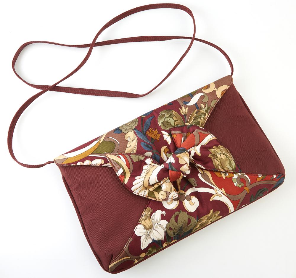 Gucci Bordeaux Floral Silk Envelope Shoulder Bag, with: Gucci Bordeaux Floral Silk Envelope Shoulder Bag, with golden brass accents and bow decoration, the snap enclosure opening to a golden silk lined interior with side zipper pocket and detachable straps