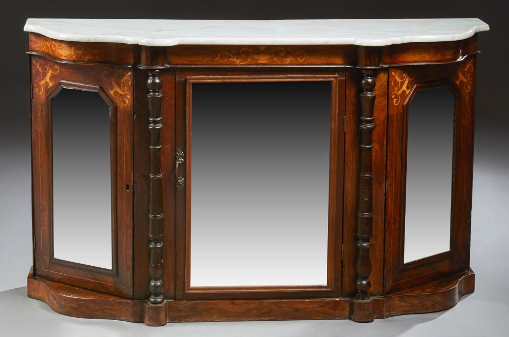 English Victorian Carved Mahogany Marble Top Credenza,: English Victorian Carved Mahogany Marble Top Credenza, 19th c., the bowed serpentine figured white marble on a base with a central mirror door flanked by applied turned columns and canted mirror door 
