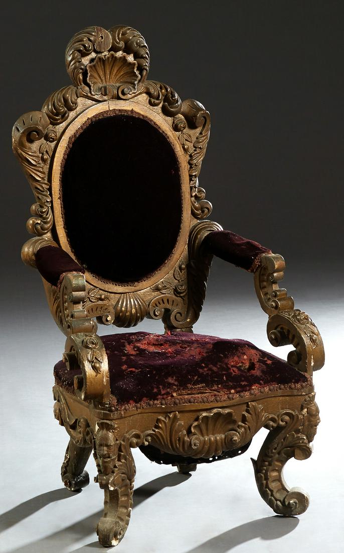 Highly Carved Gilt and Gesso Lady's or Child's Chair,: Highly Carved Gilt and Gesso Lady's or Child's Chair, c. 1900, the shell carved crest over an oval cushioned back with scrolled supports, to a cushioned serpentine seat on scrolled legs, in deep wine 