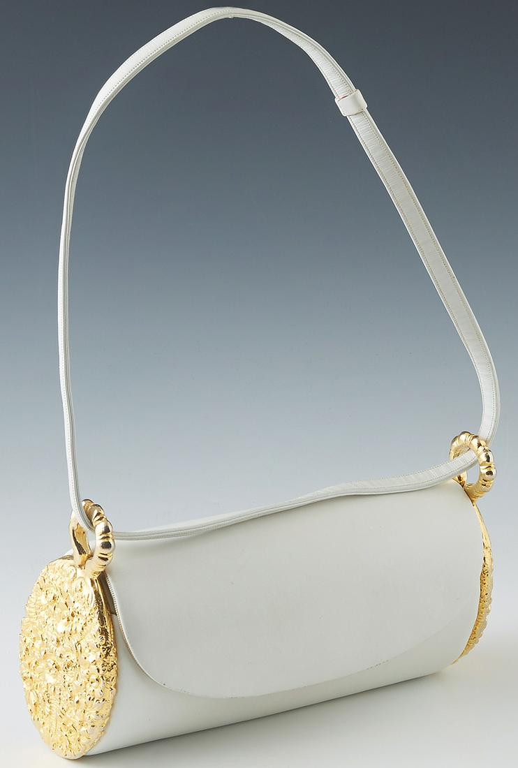 Vintage Judith Leiber White Leather and Gold Barrel: Vintage Judith Leiber White Leather and Gold Barrel Handbag, the flap with a push gold brass button clasp, opening to an open interior lined with ivory canvas, the exterior sides with gold floral meta