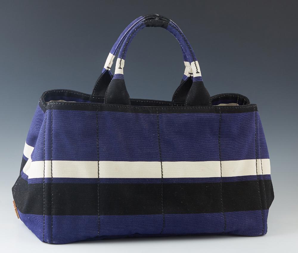 Prada Black, Navy and White Fabric Tote Bag, with: Prada Black, Navy and White Fabric Tote Bag, with double handes, the interior of the bag lined in beige canvas, one side with a zip closure pocket, the other with a zip closure pocket and two open poc